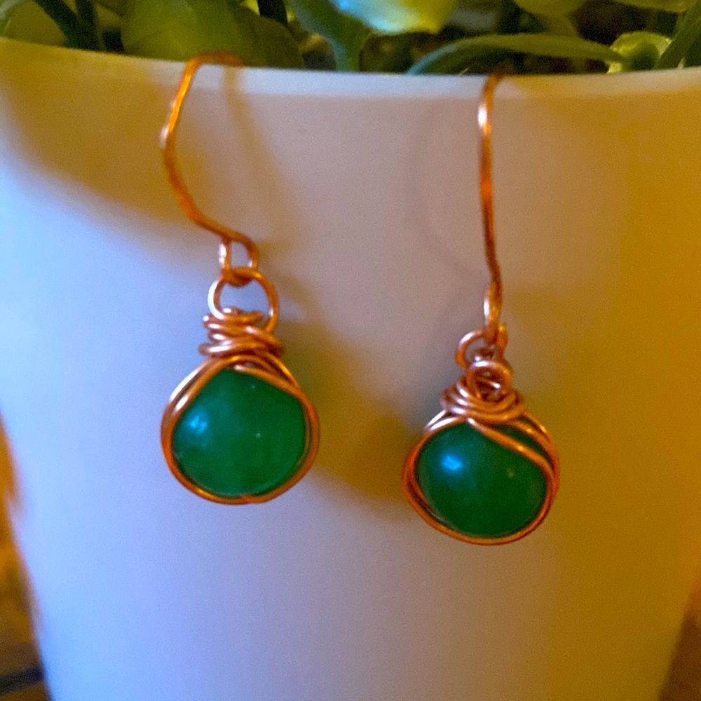 Handmade copper wire wrapped green quartz earrings.
